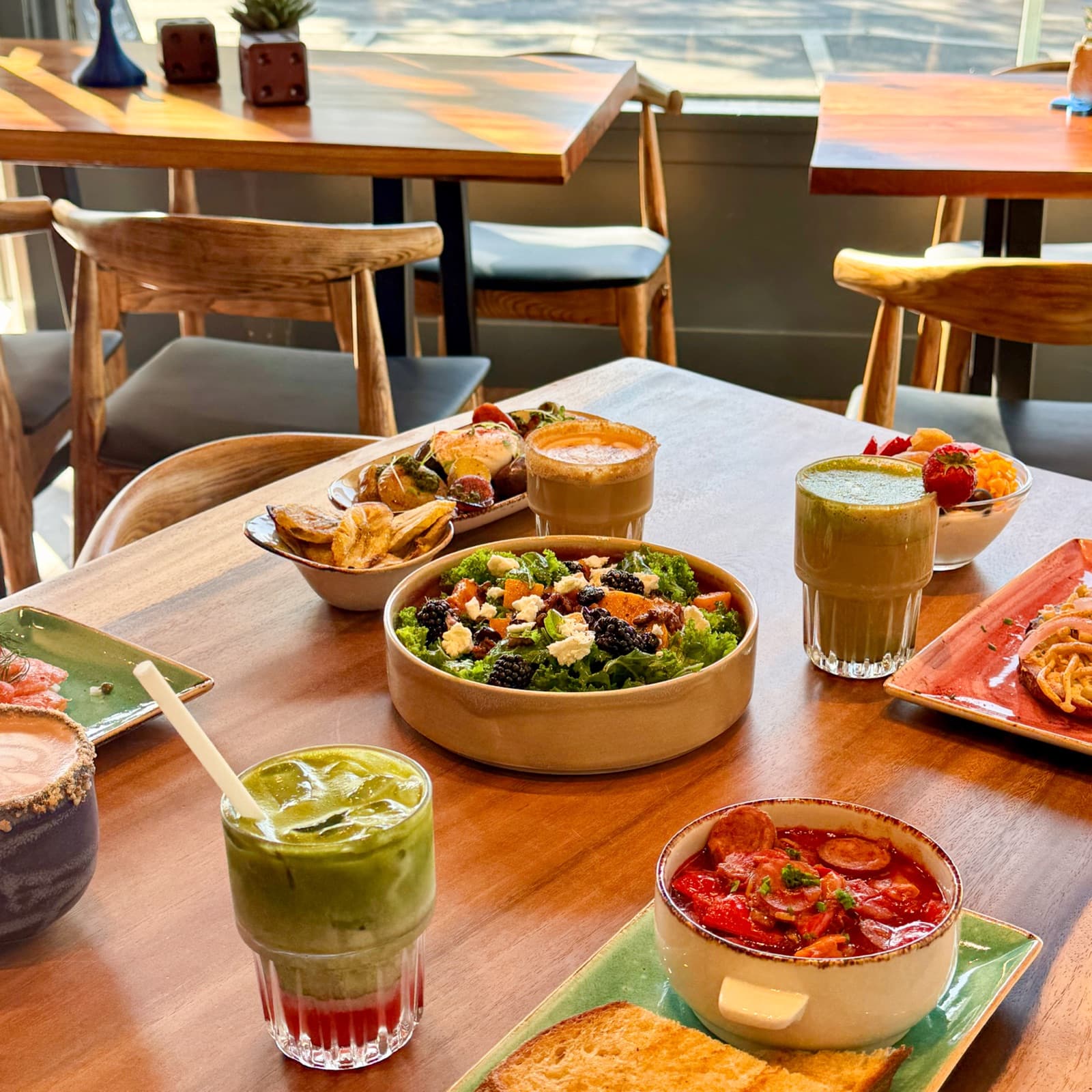 A table spread of bowls, toasts, and drinks