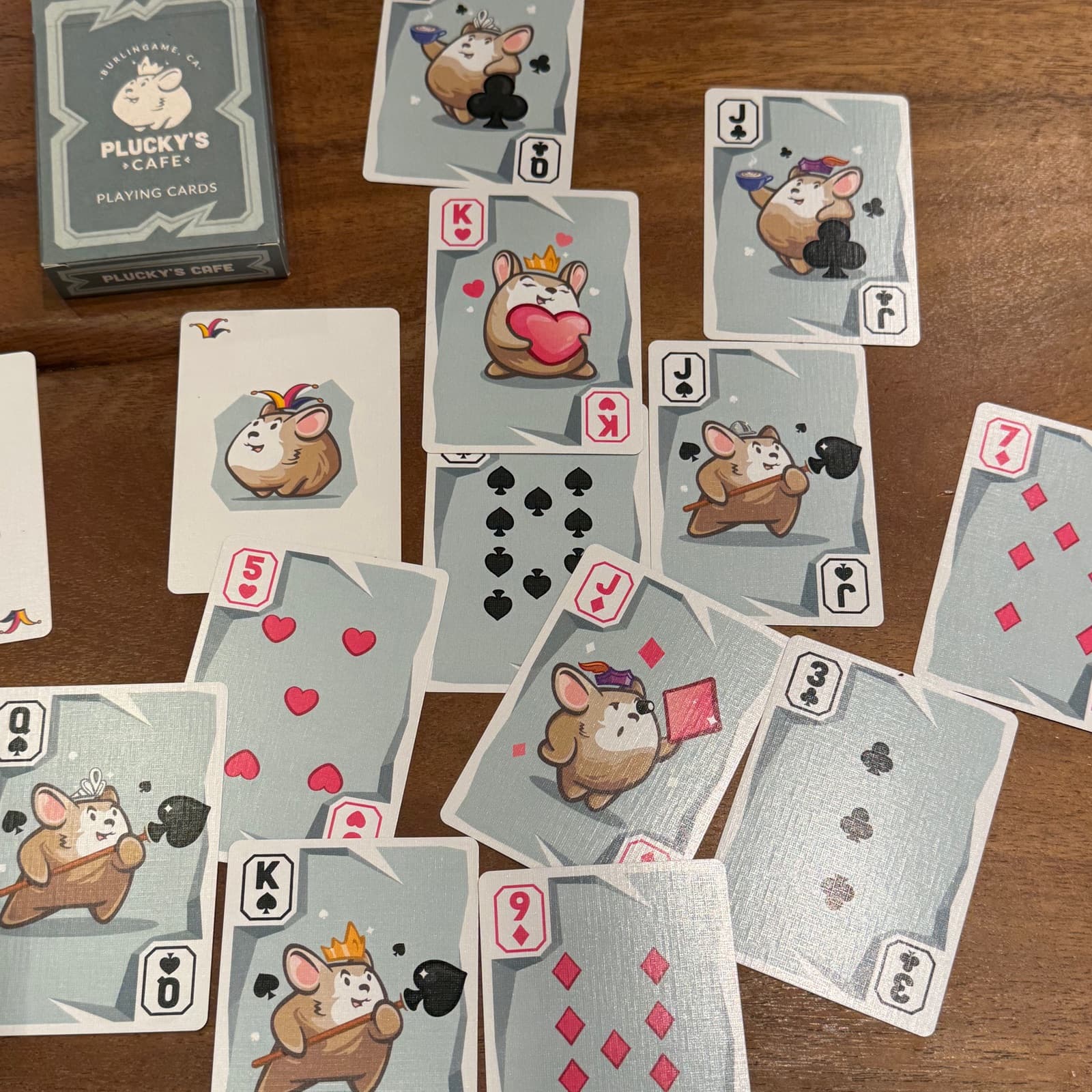 Plucky’s branded playing cards on the table