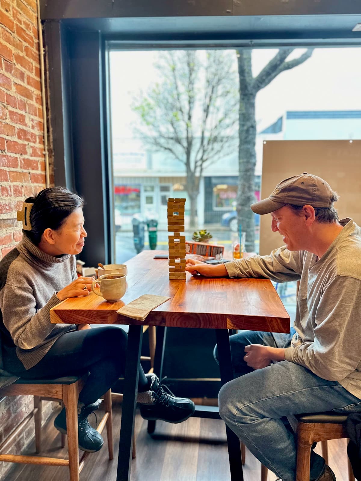 Two friends at the window over coffee and a stacking game