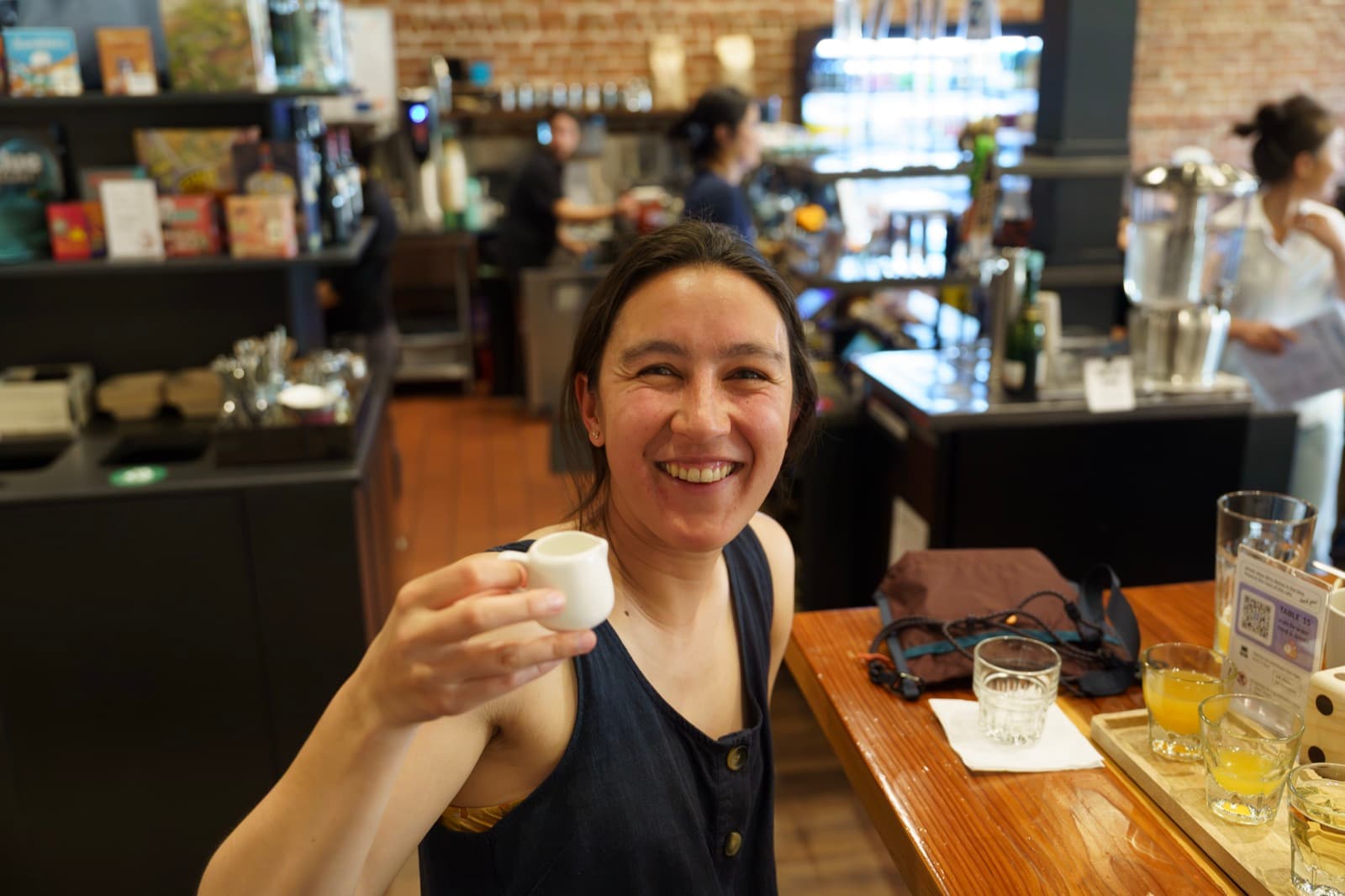 Cheers with a tiny cup at the counter