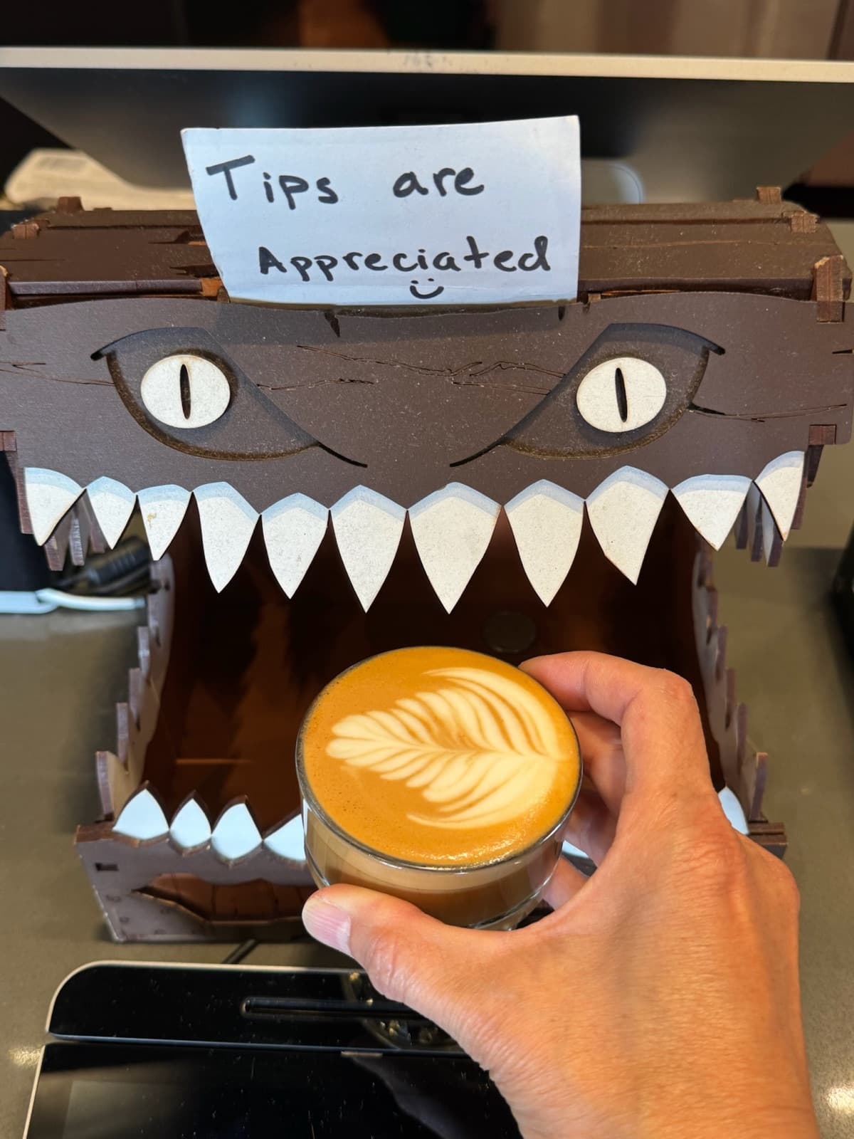 A latte in front of the tips monster